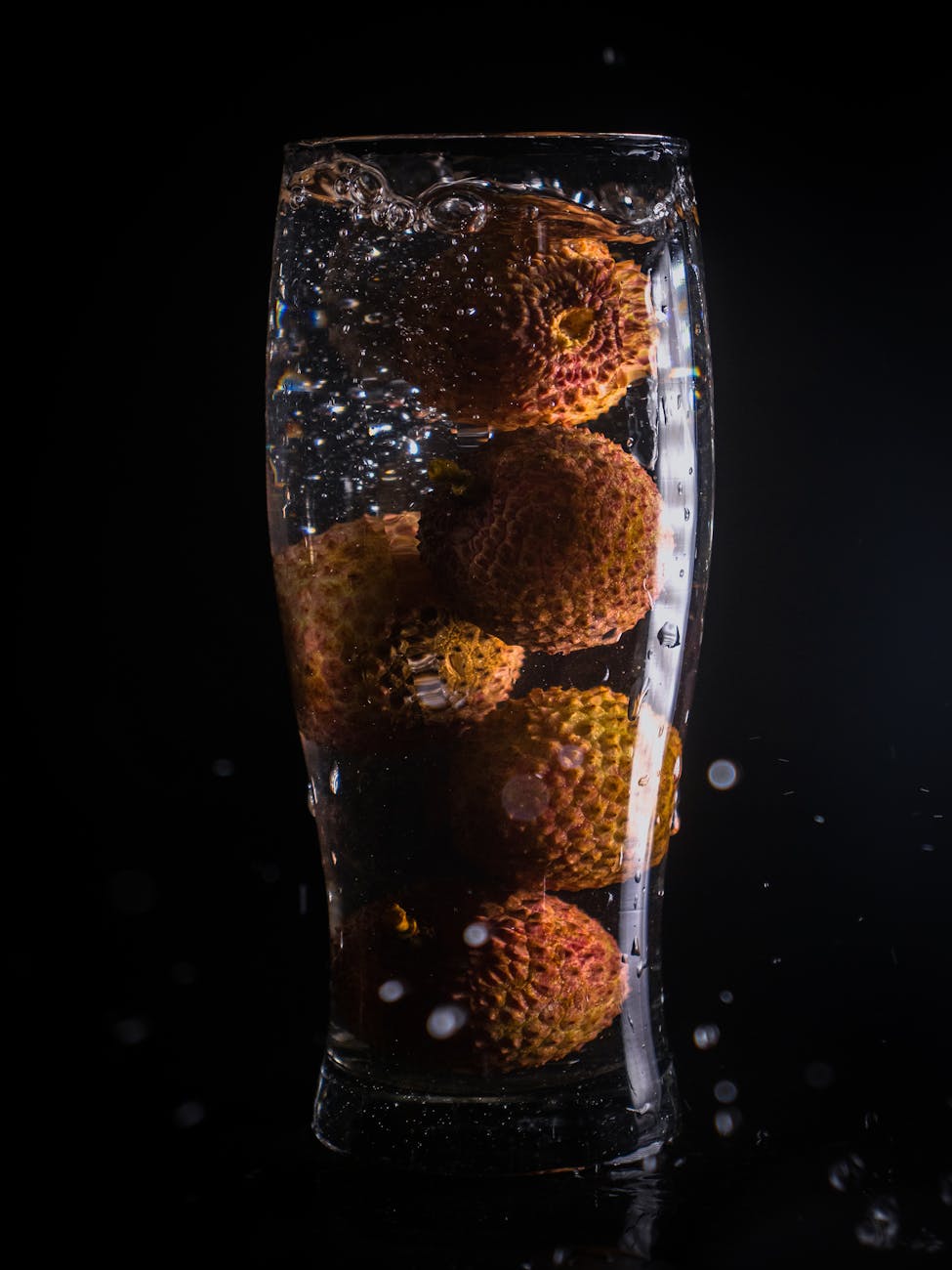 clear drinking glass with water and fruits