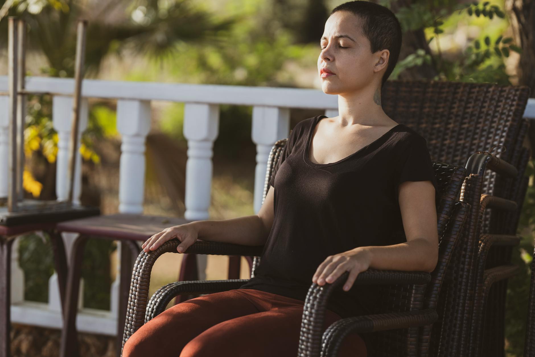 woman in black top sitting on brown armchair