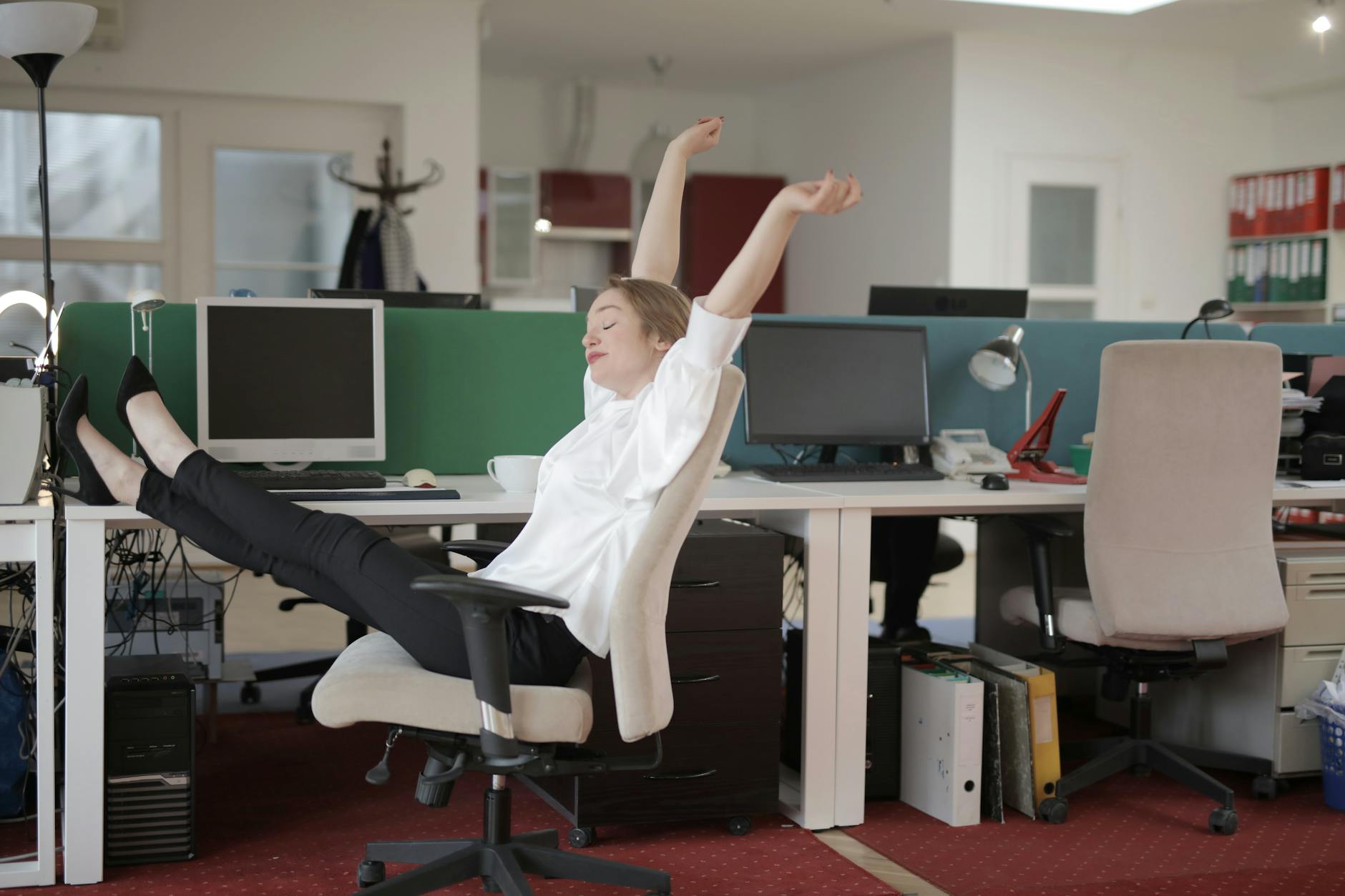 female office worker relaxing with feet on table