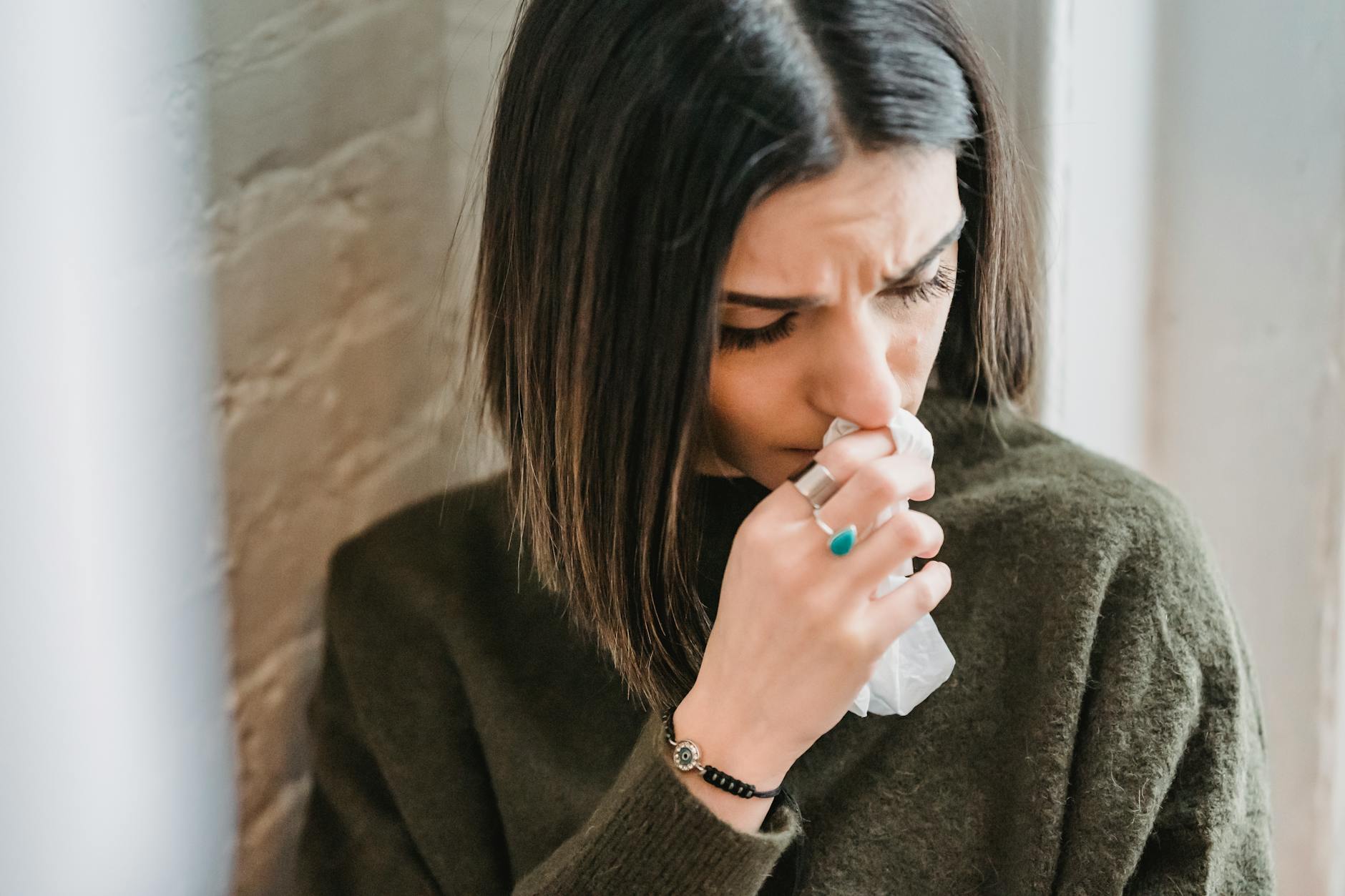 depressed woman with tissue in room