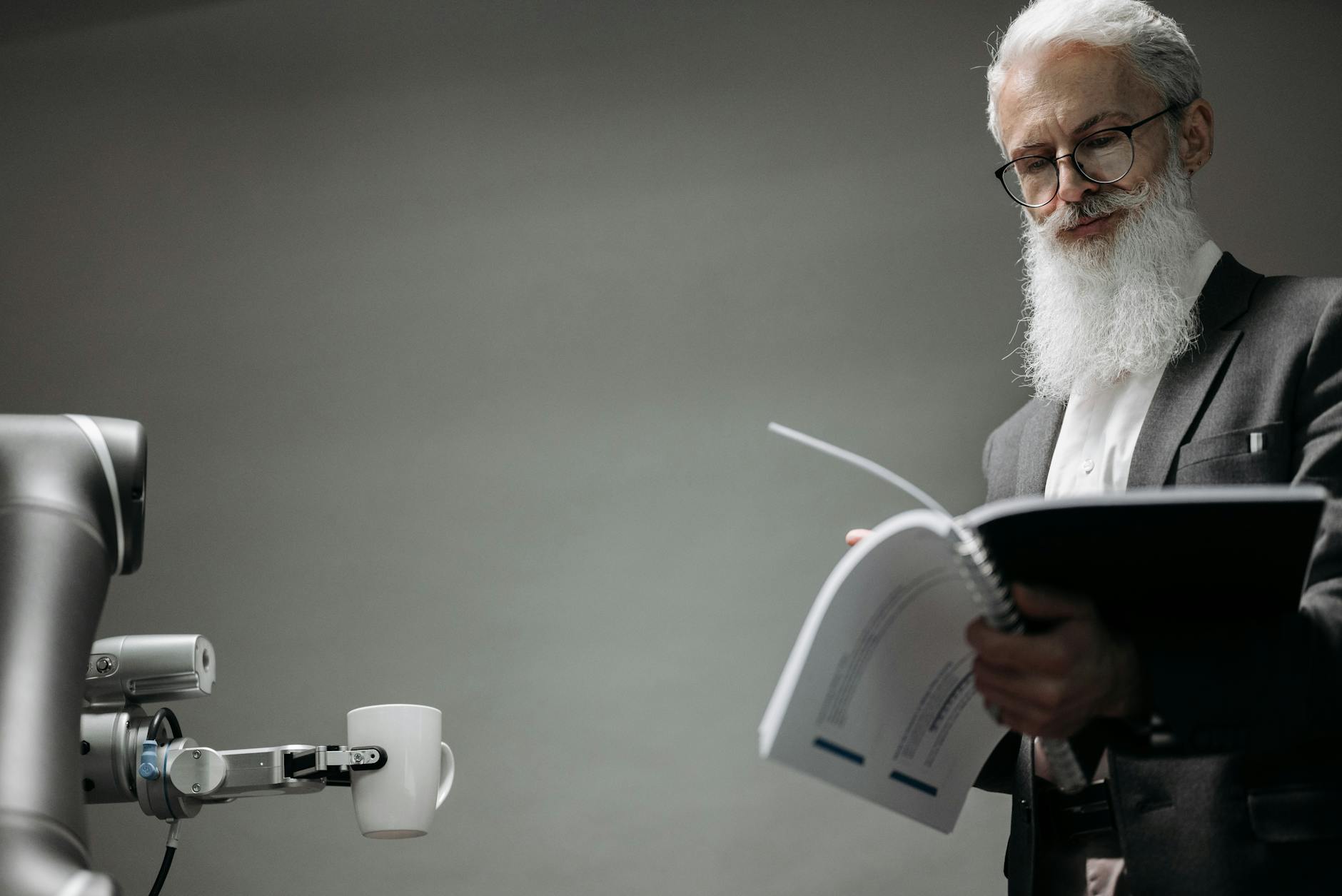 scientist reading a manual and a robot holding a cup of coffee