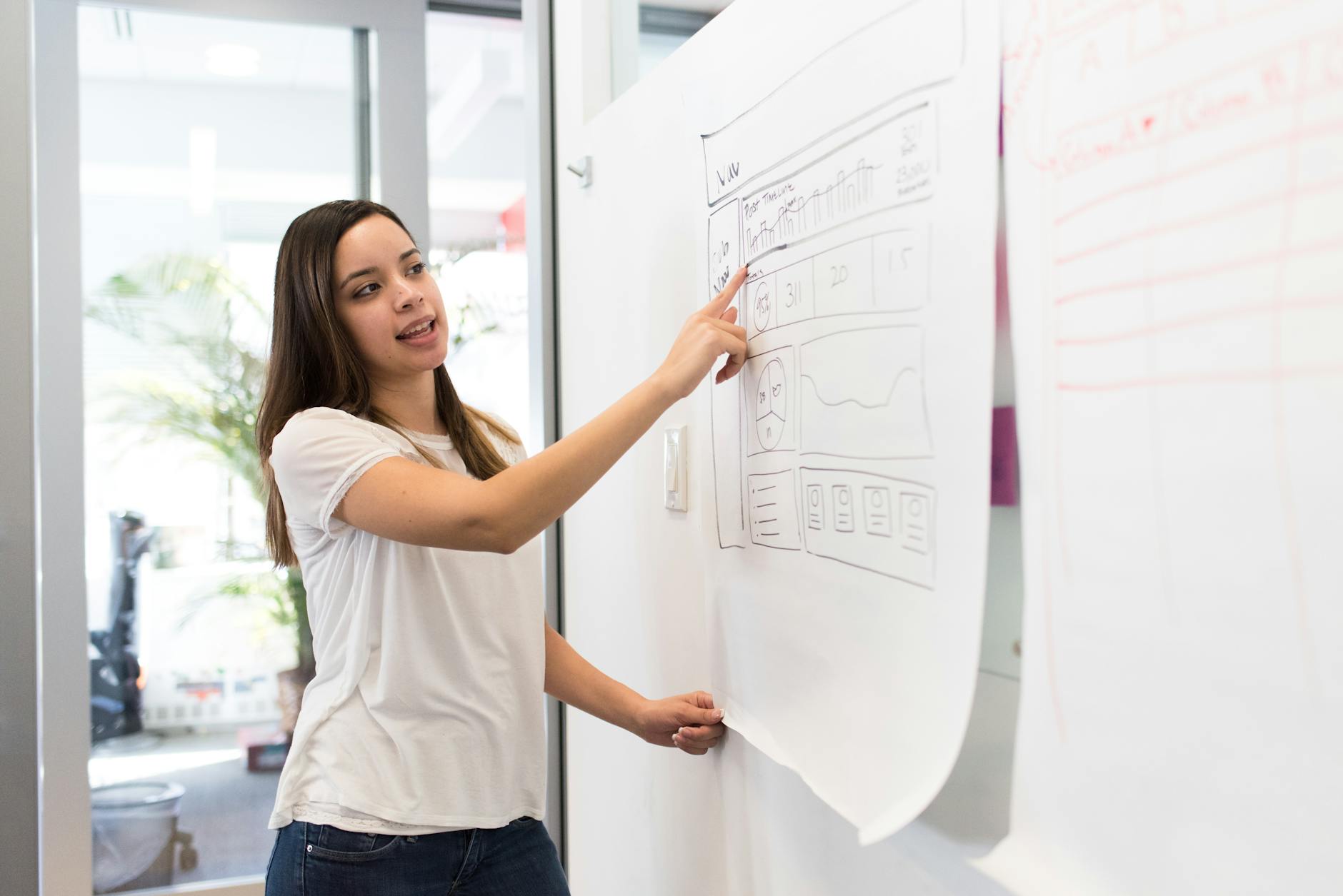 photo of woman pointing on white paper