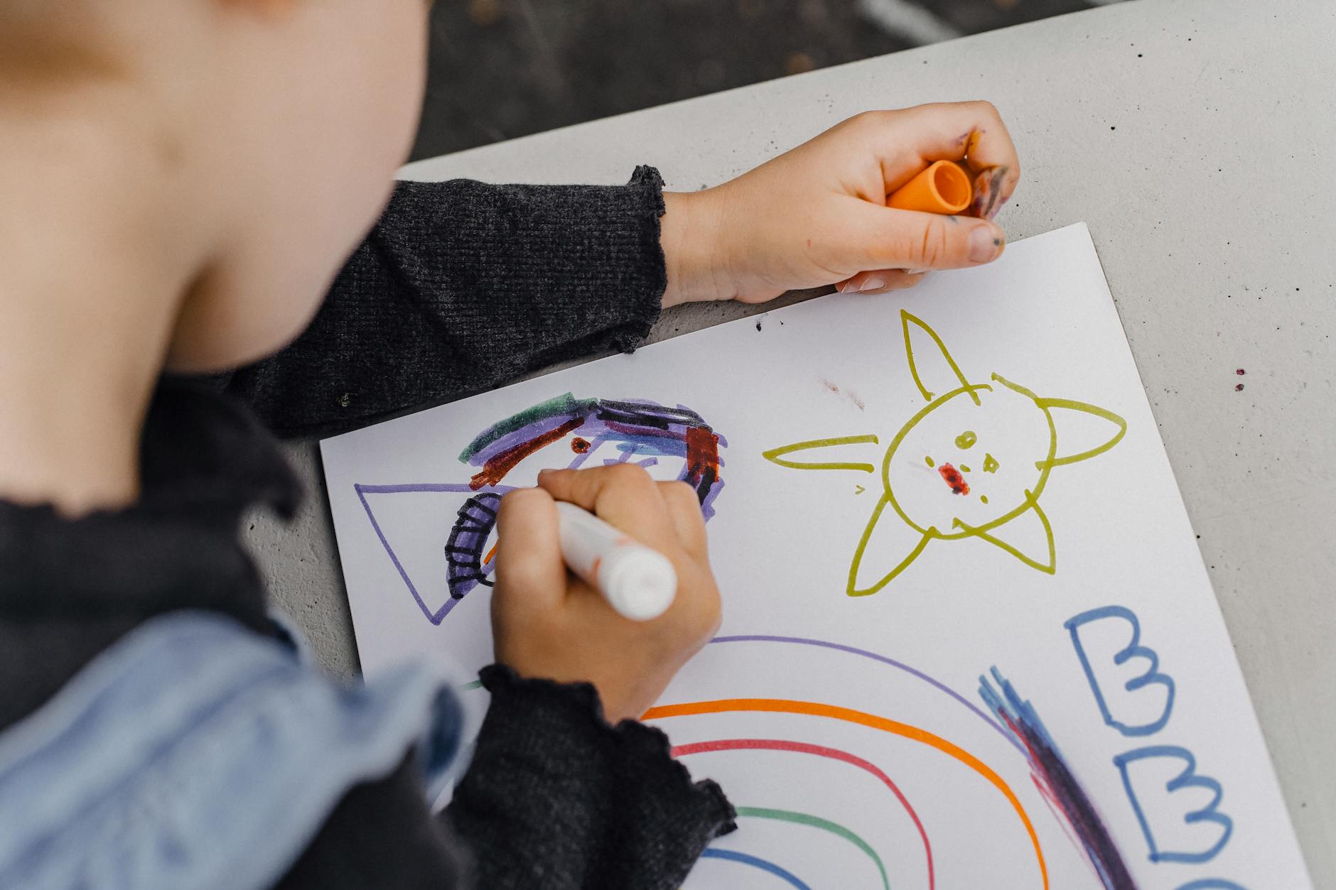 crop child drawing on sheet of paper