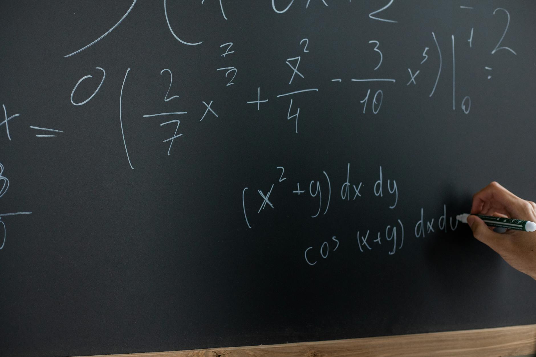 mathematical equation written on blackboard